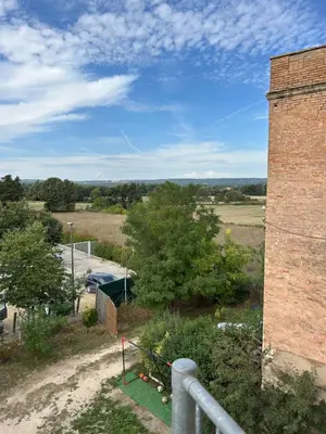 a view from the balcony of a brick building at Bel Appartement au 2 eme in Aix-en-Provence
