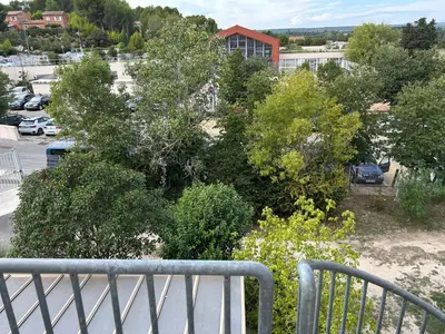 a view of a parking lot from a balcony at Bel Appartement au 2 eme in Aix-en-Provence