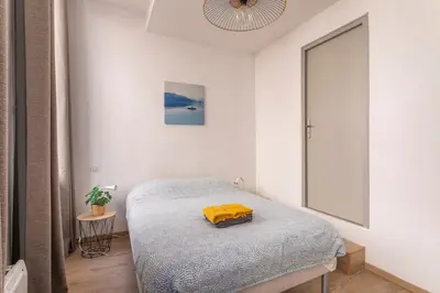 a bedroom with a bed with a yellow blanket on it at Central studio, perfect for discovering Aix on foot in Aix-en-Provence