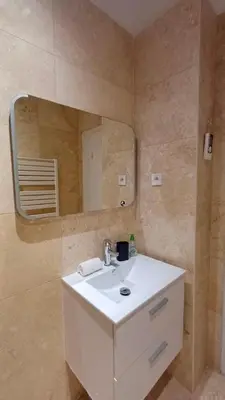a bathroom with a white sink and a mirror at Le Calisson, magnifique studio plein centre d'Aix in Aix-en-Provence
