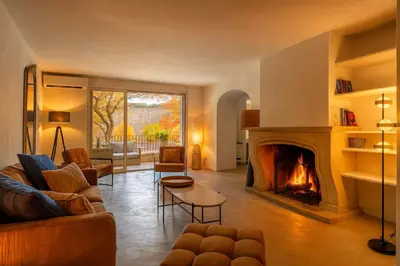 a living room with a fireplace and a couch at LOasis de Gordes Provence Pool Villa Retreat in Gordes