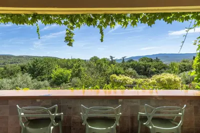 a house covered in ivy on a road at Le Mas Jorel Luxury Pool Villa with Mountain View in Gargas