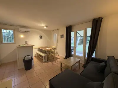 a flat screen tv on a wall with a small cabinet at Maison t3 climatisée avec accès piscine à vagues, Domaine de Pont Royal - FR-1-658-37 in Mallemort