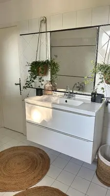 a white bathroom with a sink and a mirror at Art Appartement Kristina 80m2 in Graminier