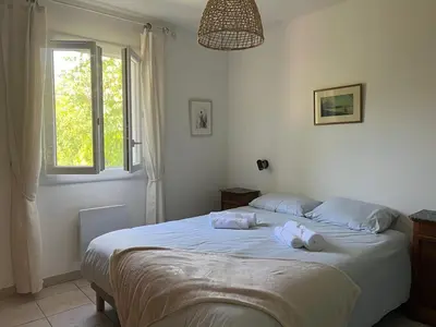 a bedroom with a bed with two towels on it at Maison provençale avec jardin et piscine à Lambesc in Lambesc