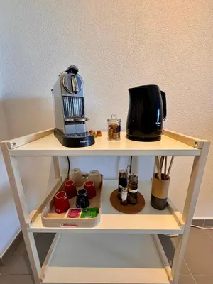 a shelf with a coffee maker and a toaster on it at Terrasse, clim et piscine à Aix-en-Provence in Aix-en-Provence