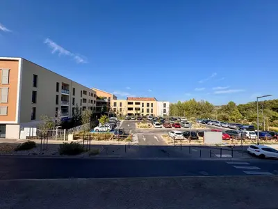 a parking lot with cars parked in a parking lot at Terrasse, clim et piscine à Aix-en-Provence in Aix-en-Provence