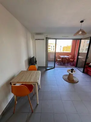 a room with a table and chairs and a dining room at Terrasse, clim et piscine à Aix-en-Provence in Aix-en-Provence