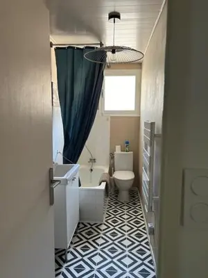 a bathroom with a toilet and a sink and a window at Cocon douillet près du Cours Sextius in Aix-en-Provence