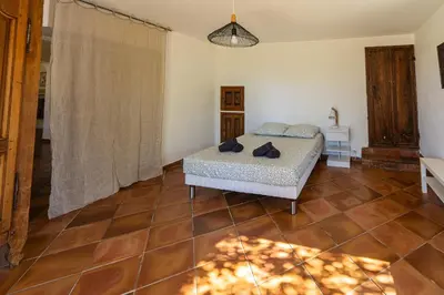 a bedroom with a bed and a tiled floor at Mas Provençal au Cœur des Vignes du Luberon - 3 Chambres - Calme Absolu - Wifi in La Tour-dʼAigues