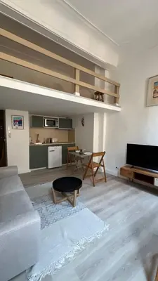a living room with a couch and a table at Un cocon au cœur de Aix in Aix-en-Provence