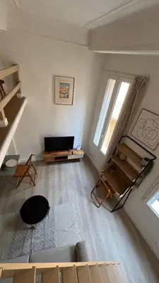 a living room with a couch and a table at Un cocon au cœur de Aix in Aix-en-Provence