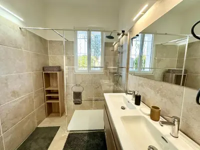 a bathroom with a sink and a mirror at Villa Maguy - Piscine et jardin privée - Proche centre ville Aix en Provence - Parking - Boulodrome - Plancha in Aix-en-Provence