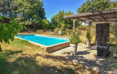 a swimming pool in a yard with a gazebo at Gîte Avec Piscine in La Tour-dʼAigues