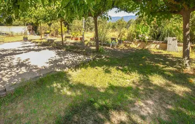a park with trees and grass in a field at Gîte Avec Piscine in La Tour-dʼAigues
