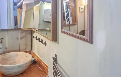 a bathroom with a large stone bowl on the wall at Gîte Avec Piscine in La Tour-dʼAigues
