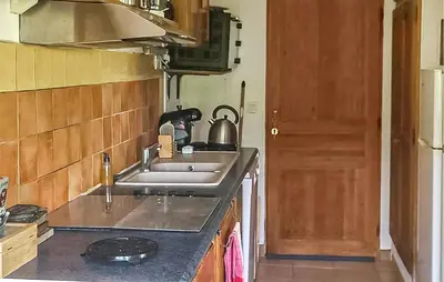 a kitchen with a sink and a counter top at Gîte Avec Piscine in La Tour-dʼAigues