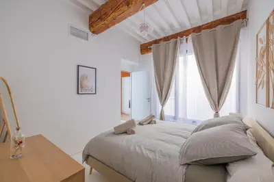 a bedroom with a bed and a desk and a window at Appartement Belle Lettre 7 in Aix-en-Provence