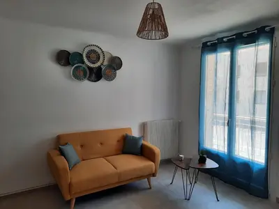 a living room with a couch and a window at Appartement Le Cézanne in Aix-en-Provence