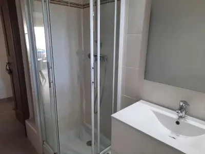 a bathroom with a glass shower and a sink at Appartement Le Cézanne in Aix-en-Provence