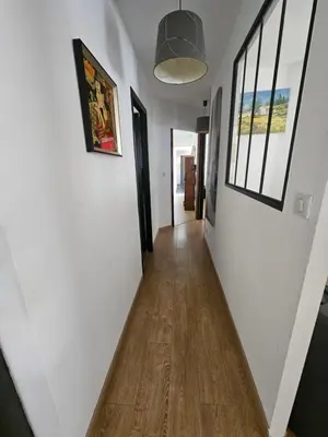 a hallway of a house with white walls and wood floors at Villa sous les pins in Ventabren