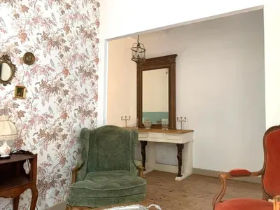 a bedroom with a bed and a table and a window at Château Sainte BARBE in Loriol-du-Comtat