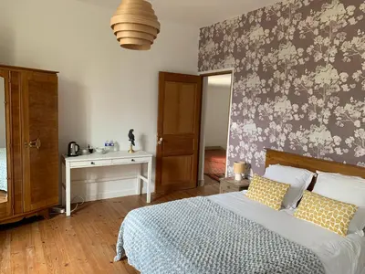 a bedroom with a bed and a desk and a window at Château Sainte BARBE in Loriol-du-Comtat