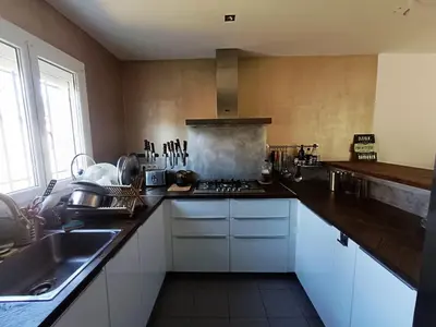 a kitchen with a sink and a stove top oven at Villa Bulle de raisin in LʼIsle-sur-la-Sorgue