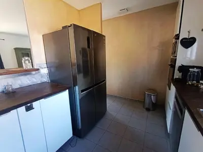 a kitchen with a large stainless steel refrigerator at Villa Bulle de raisin in LʼIsle-sur-la-Sorgue