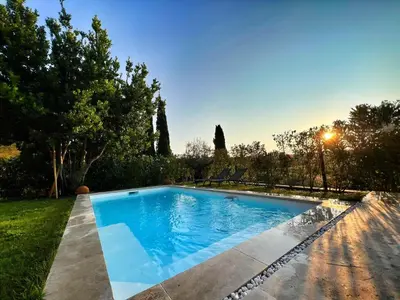 a swimming pool in the backyard of a house at Le Moulin in Aix-en-Provence