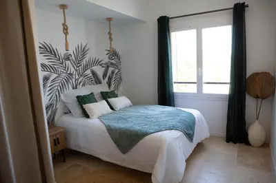a bedroom with a bed and a large window at Le Moulin in Aix-en-Provence