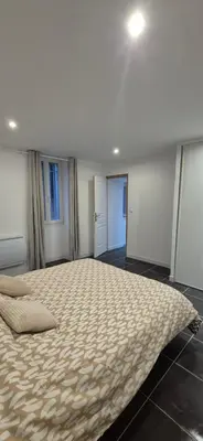 a bedroom with a large bed in a room at Appartement T3 Refait a neuf in Mazan
