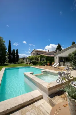 a swimming pool in the backyard of a house at Mas Coeur Provence Calme Beauté Grand Parc in Pernes-les-Fontaines