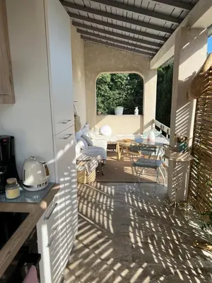 a view of a patio with a table and a couch at Mas Coeur Provence Calme Beauté Grand Parc in Pernes-les-Fontaines