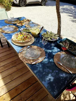 a table with plates of food and wine glasses on it at Le Picholine in Mazan