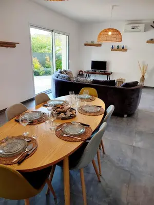 a dining room with a table and a couch at Le Picholine in Mazan