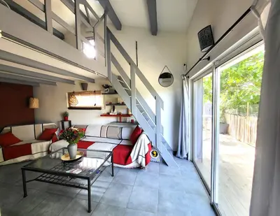 a living room with a couch and a staircase at Pasca'land in Velaux
