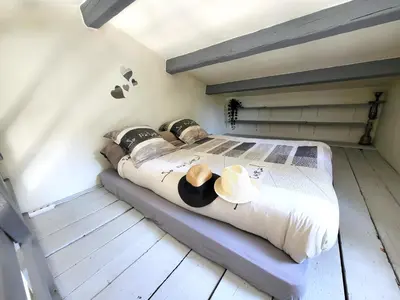 a bedroom with a bed with two hats on it at Pasca'land in Velaux