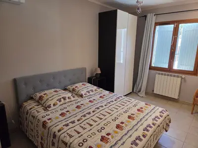 a bedroom with a bed with a quilt on it at Villa avec piscine privée in Alleins