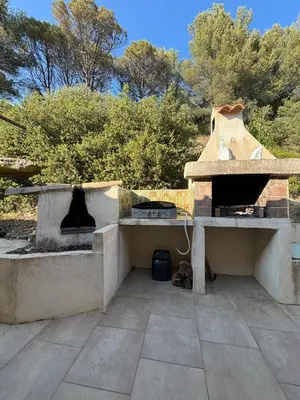 a stone oven sitting on top of a patio at Lourmarin Family Country House in Cadenet