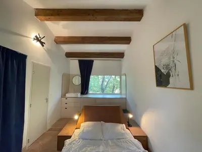 a bedroom with a bed and a window at La Régalade in Le Puy-Sainte-Réparade