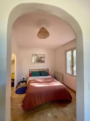 a bedroom with a large bed with a ceiling at La Régalade in Le Puy-Sainte-Réparade