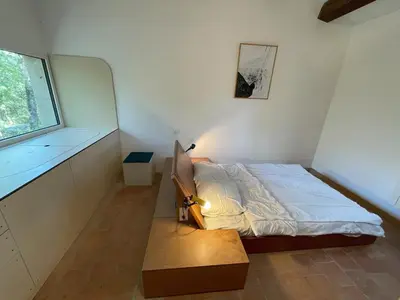 a small bedroom with a bed and a window at La Régalade in Le Puy-Sainte-Réparade