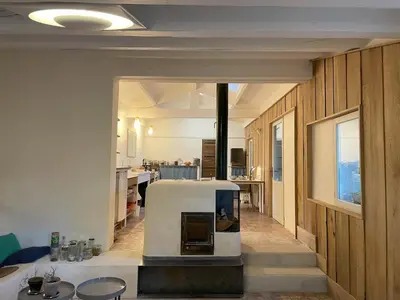 a kitchen with a stove in the middle of a room at La Régalade in Le Puy-Sainte-Réparade