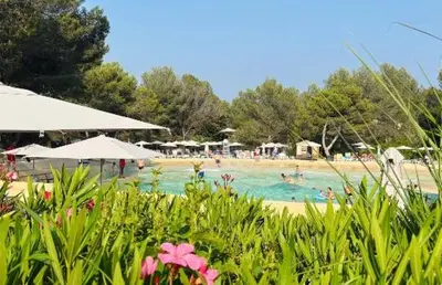 a group of people in a swimming pool at a beach at Domaine de Pont royal in Mallemort