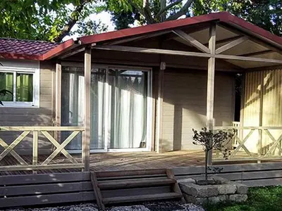 a small house with a porch and a deck at Chalet 46m² avec Terrasse à Noves - API-1-52-531 in Noves