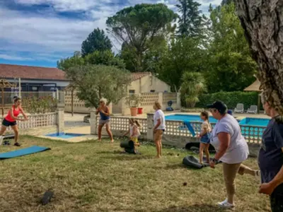 a group of people playing a game in a yard at Chalet confort avec terrasse - 5 personnes - API-1-52-621 in Noves
