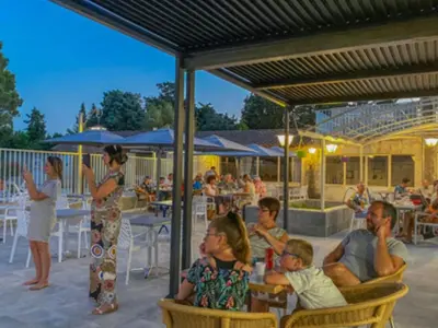 a group of people sitting in chairs at a restaurant at Chalet 3 pièces avec terrasse, 4 pers, confort et calme - API-1-52-742 in Noves