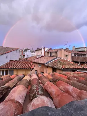 a rainbow over the roofs of a city at Appartement cocooning centre ville in Aix-en-Provence