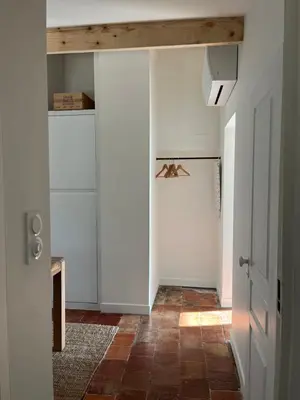 a hallway with white walls and a wooden ceiling at Appartement cocooning centre ville in Aix-en-Provence